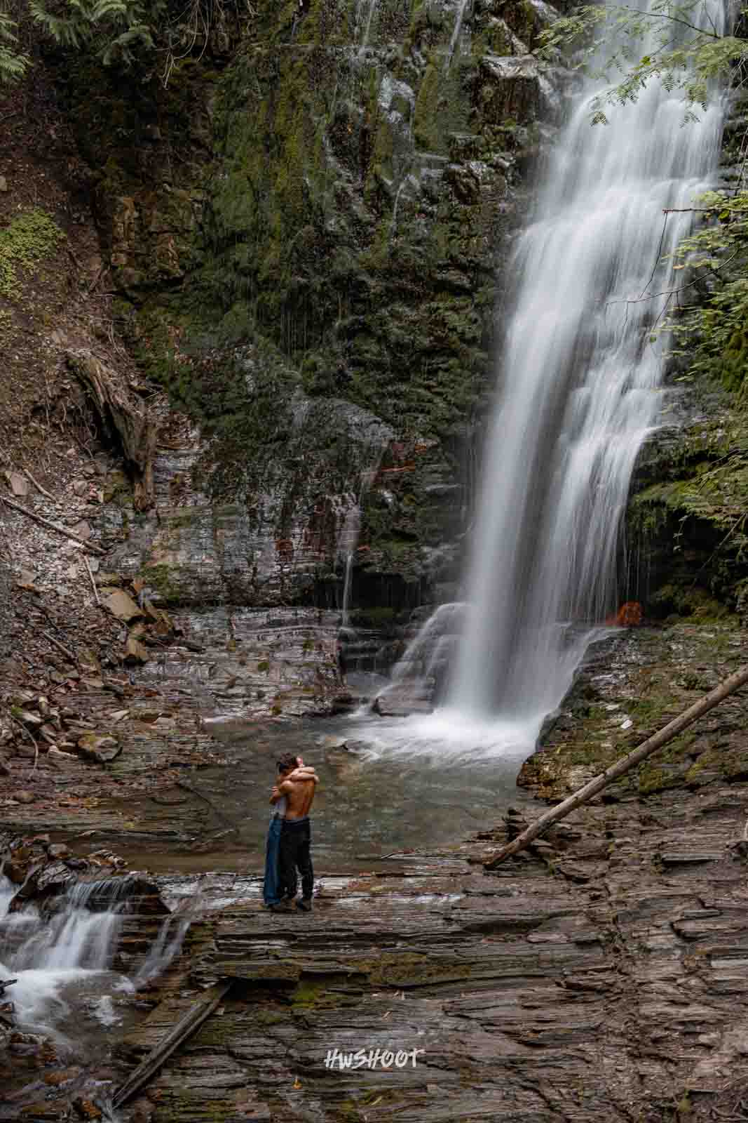 Calgary couple photography by a waterfall